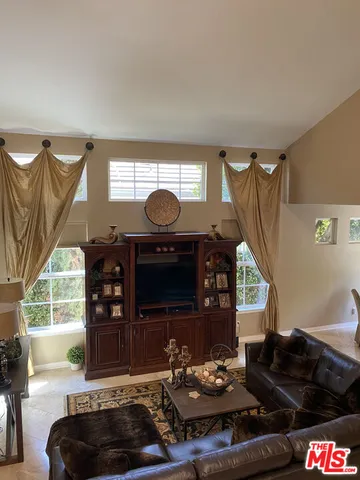 a dining room with furniture and a chandelier