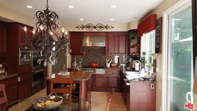 a stove top oven sitting inside of a kitchen
