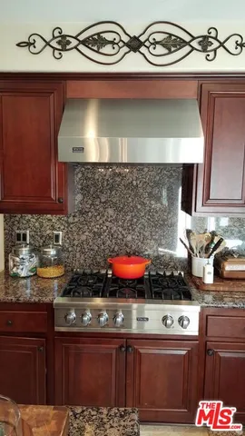 a living room with furniture a large window and a fireplace