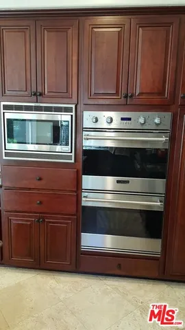 a living room with furniture a fireplace and a flat tv screen next to a window