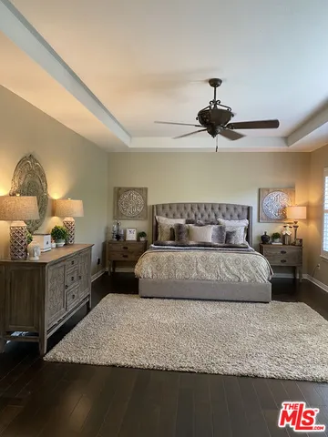 a bedroom with a bed and a potted plant