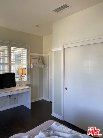 a bathroom with a granite countertop sink mirror vanity and toilet