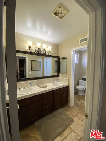 a en suite bathroom with a toilet sink and mirror