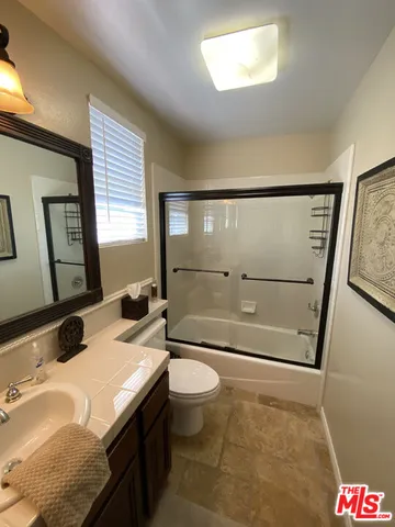 a view of swimming pool with a yard and large trees