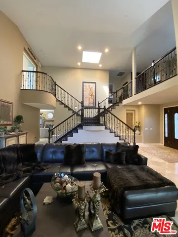 a living room with lots of furniture and stairs