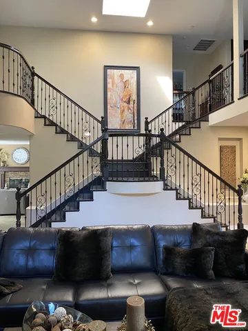 a living room with furniture and a stairs