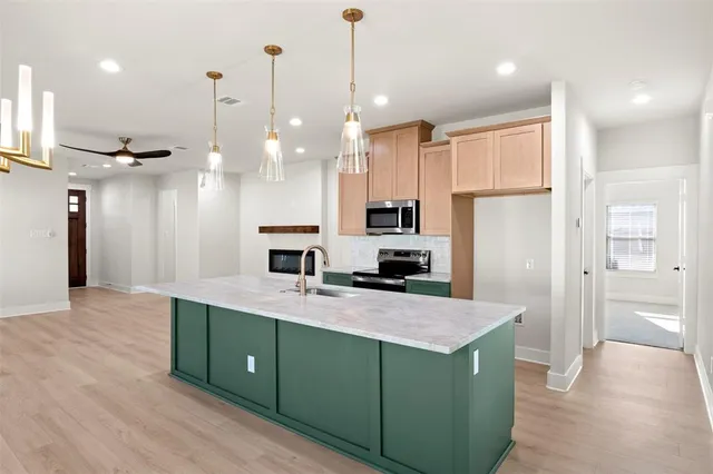 a kitchen with a sink stove and microwave
