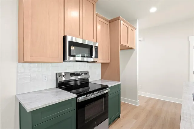a kitchen with a stove and a microwave