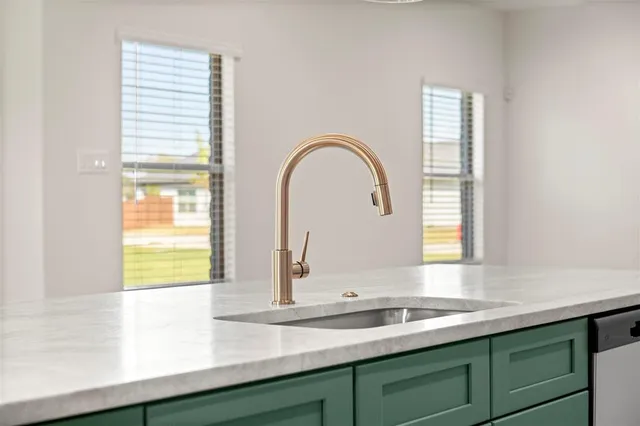 a kitchen with stainless steel appliances granite countertop a sink and a microwave