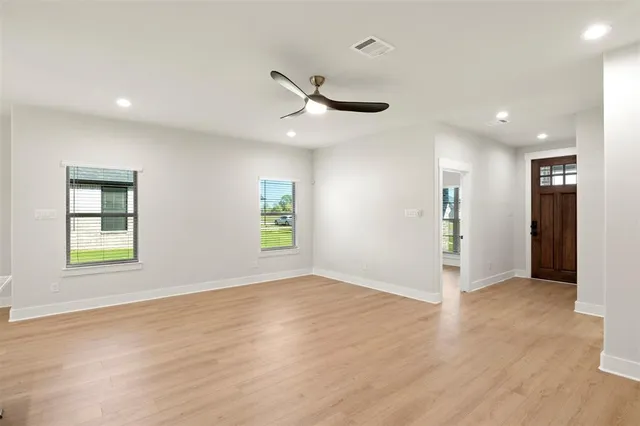 a kitchen with kitchen island granite countertop a sink a counter space appliances and cabinets