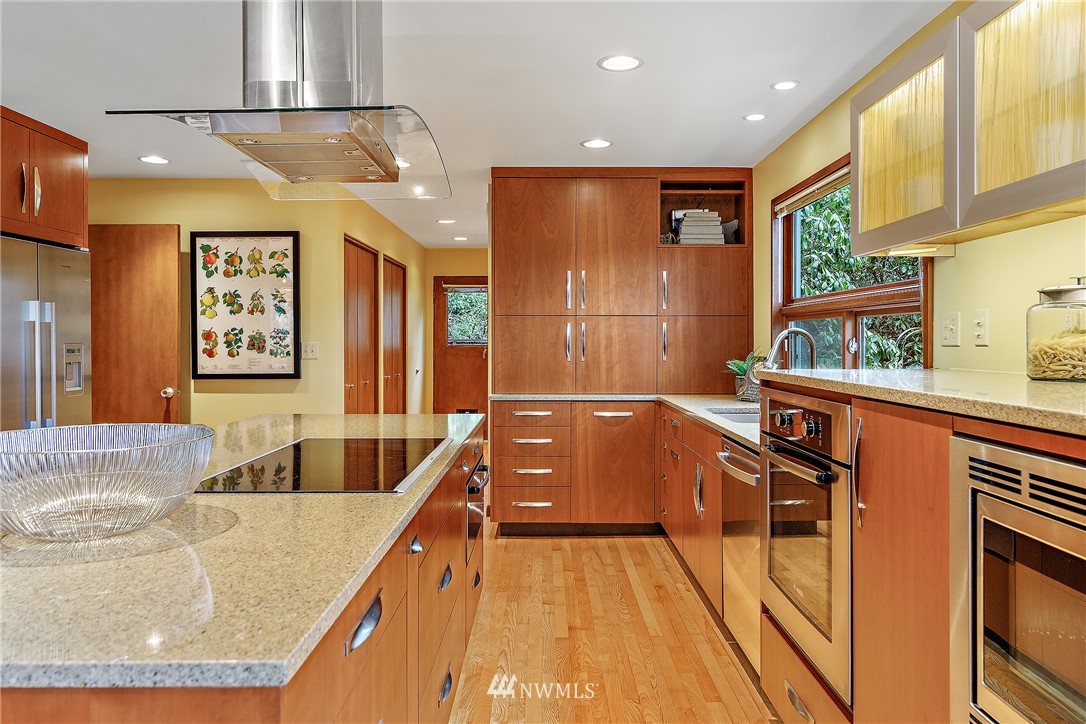 8316 Olympic View Drive Edmonds, WA 98026 - Photo 13 of 38 a kitchen with stainless steel appliances granite countertop a sink and wooden cabinets