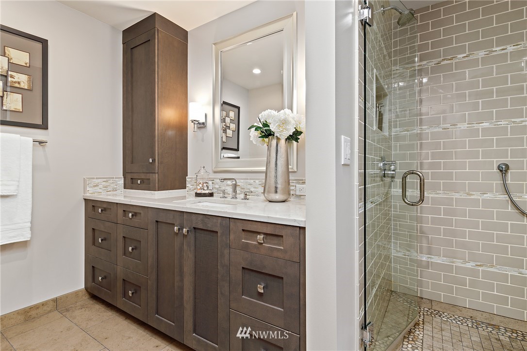 8316 Olympic View Drive Edmonds, WA 98026 - Photo 18 of 38 a bathroom with a granite countertop sink a mirror and shower