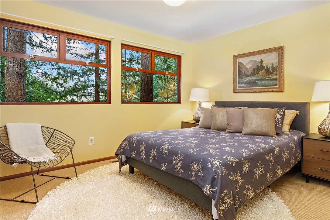 8316 Olympic View Drive Edmonds, WA 98026 - Photo 20 of 38 a bedroom with a bed and chair next to a large window
