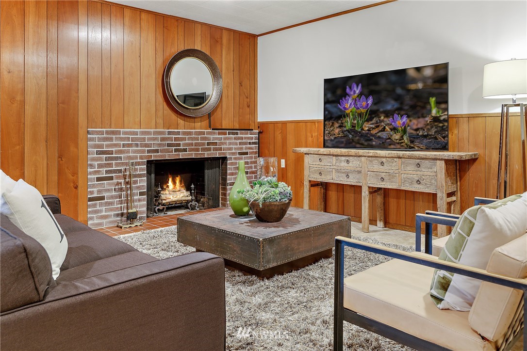 8316 Olympic View Drive Edmonds, WA 98026 - Photo 26 of 38 a living room with furniture a flat screen tv and a fireplace