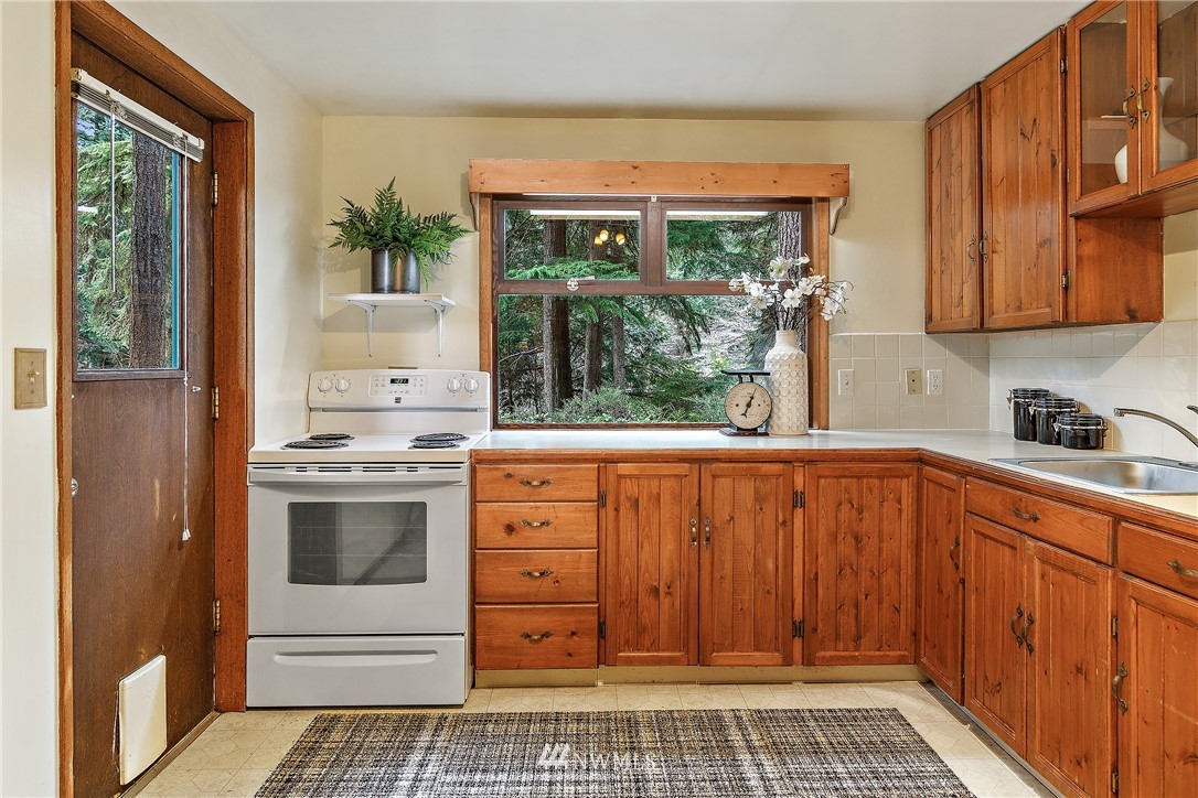 8316 Olympic View Drive Edmonds, WA 98026 - Photo 27 of 38 a kitchen with granite countertop a stove a sink and a cabinets