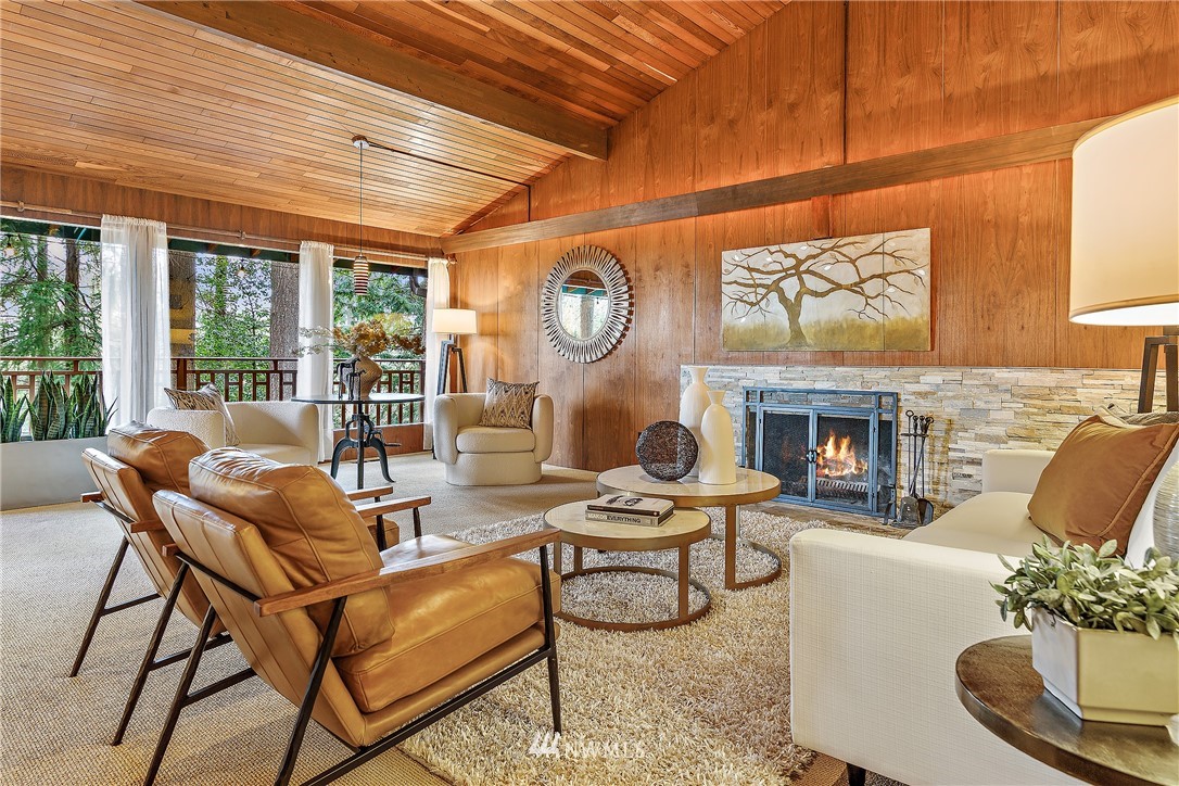 8316 Olympic View Drive Edmonds, WA 98026 - Photo 9 of 38 a living room with furniture a fireplace and a large window