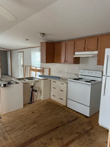 a kitchen with a stove a sink and a refrigerator