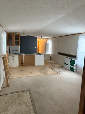 an empty room with furniture and window