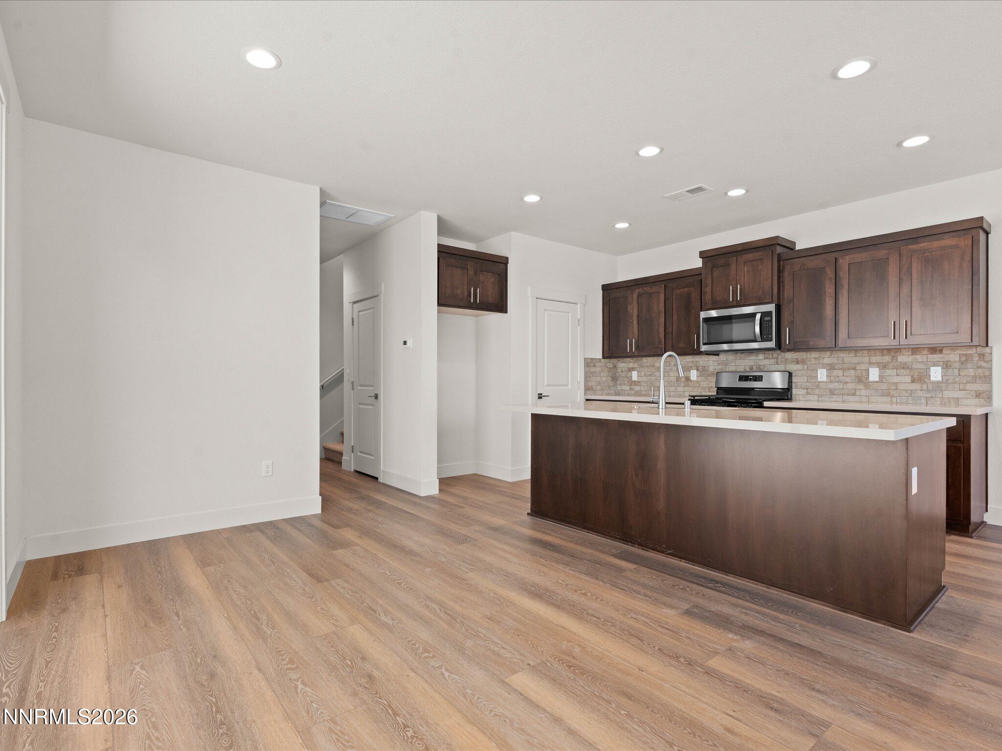 1371 Vine Gate Road, Unit HOMESITE 49 Carson City, NV 89701 - Photo 6 of 24 a kitchen with granite countertop a refrigerator and a stove top oven