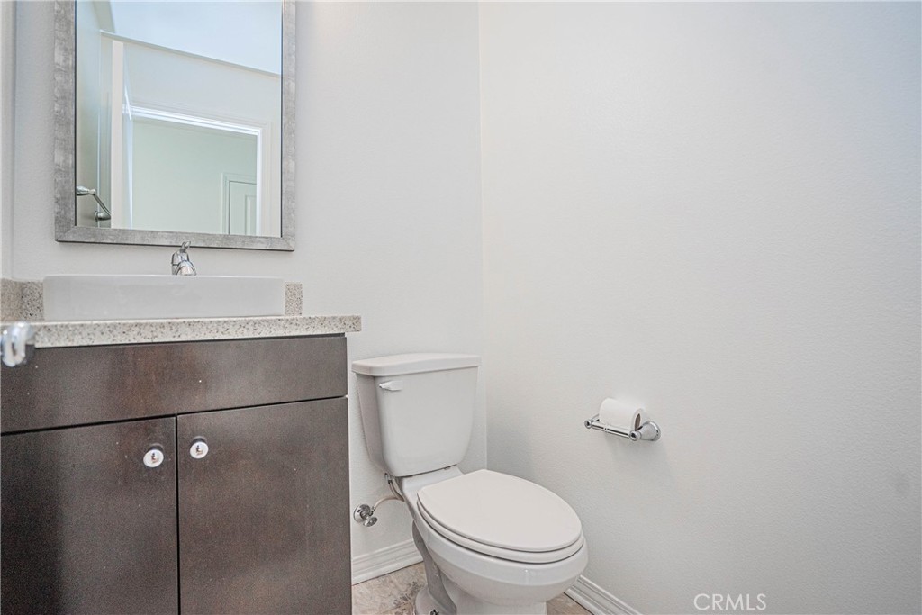 645 Liberation Way Fullerton, CA 92832 - Photo 11 of 20 a bathroom with a toilet sink vanity and mirror