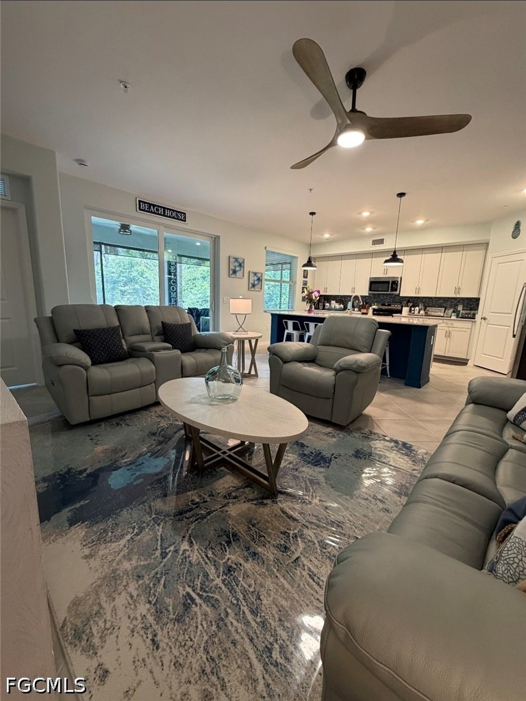 14191 Poppy Fld Loop, Unit 5312 Punta Gorda, FL 33955 - Photo 13 of 41 a living room with furniture and a large window