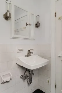 a white bath tub sitting next to a white toilet