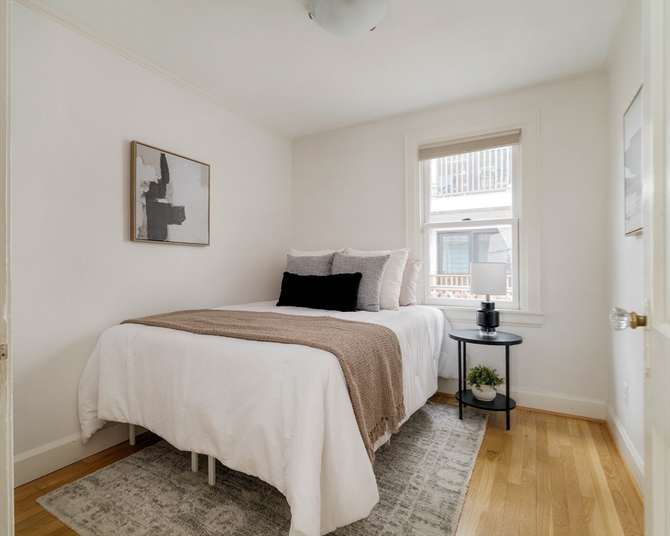 277 Lamartine Street Boston, MA 02130 - Photo 18 of 28 a bedroom with a bed and wooden floor