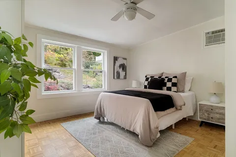 a bedroom with a bed window and potted plant