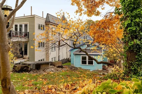 a view of a chairs and table in a backyard
