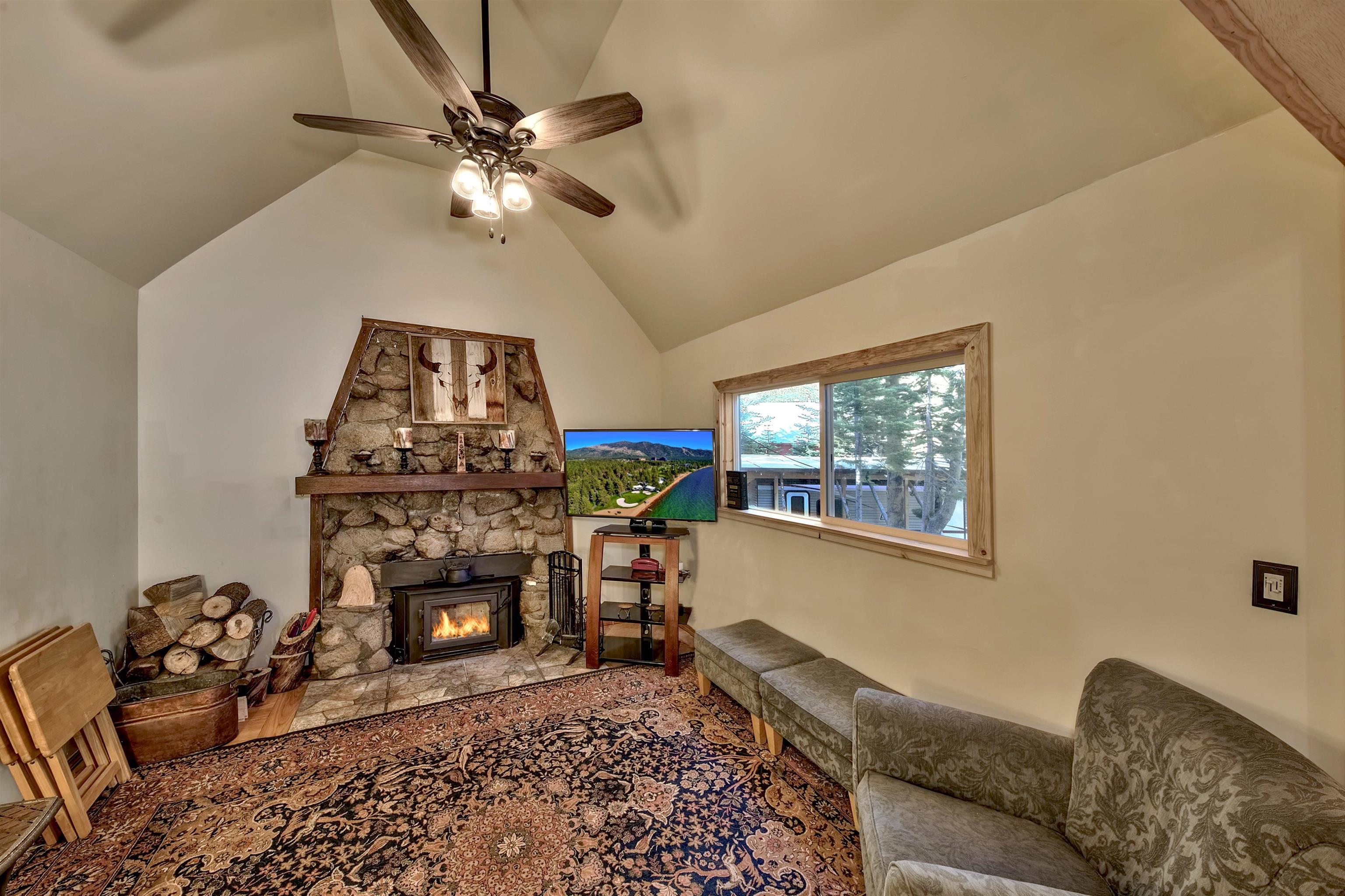 12065 Bums Gulch Road Reno, NV 89511 - Photo 13 of 21 a living room with furniture a window and a fireplace