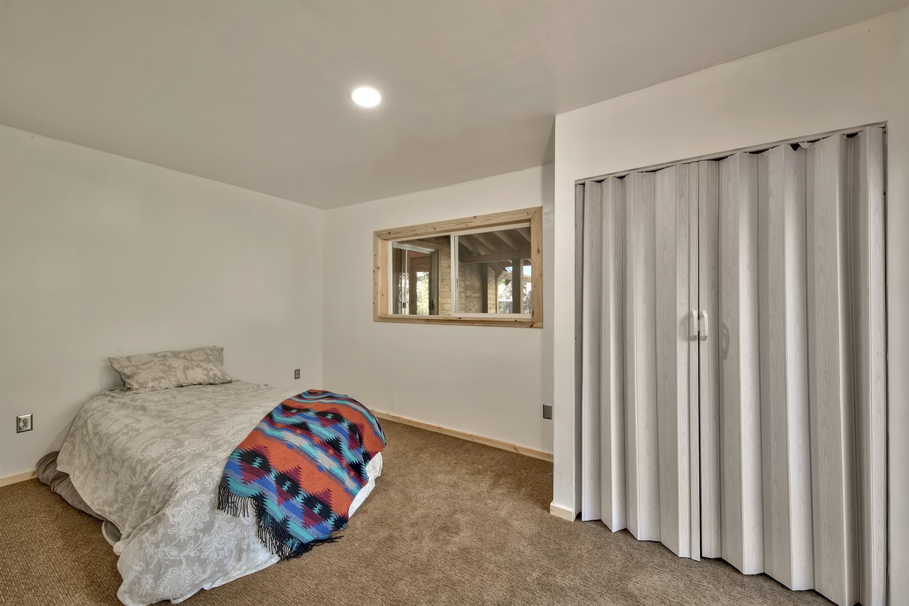 12065 Bums Gulch Road Reno, NV 89511 - Photo 14 of 21 a bedroom with a bed and a window