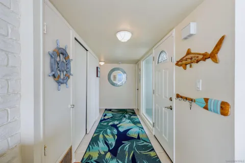a view of a hallway with wooden floor and furniture