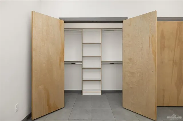 a view of walk in closet with empty racks