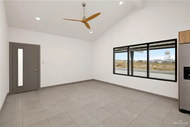 an empty room with windows and city view