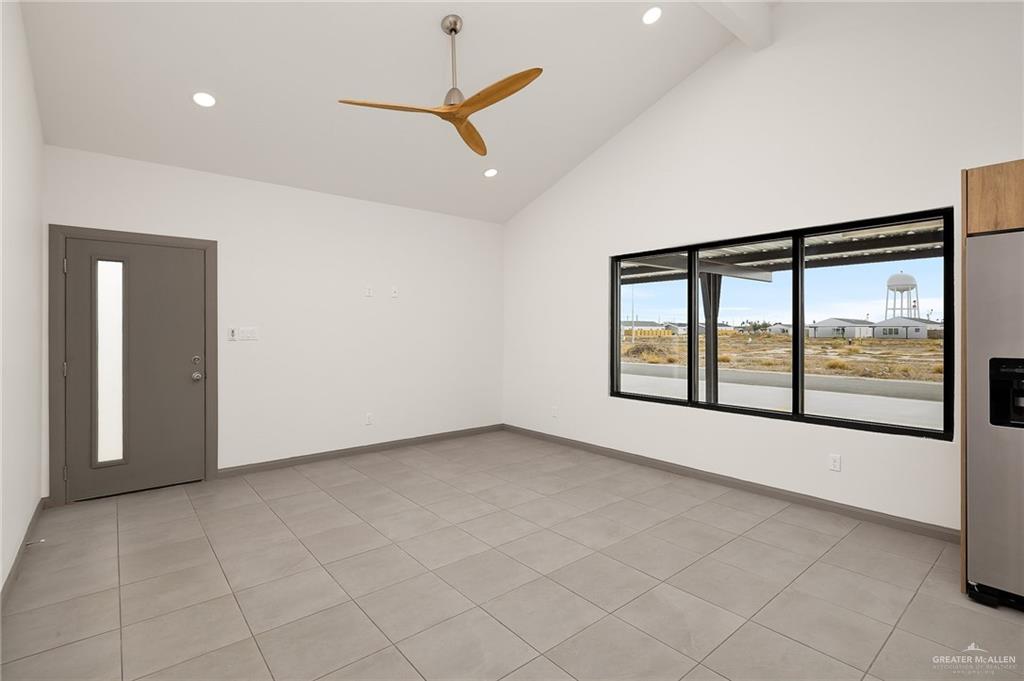 2609 Woodpecker Road, Unit 1 Weslaco, TX 78596 - Photo 5 of 18 an empty room with windows and city view