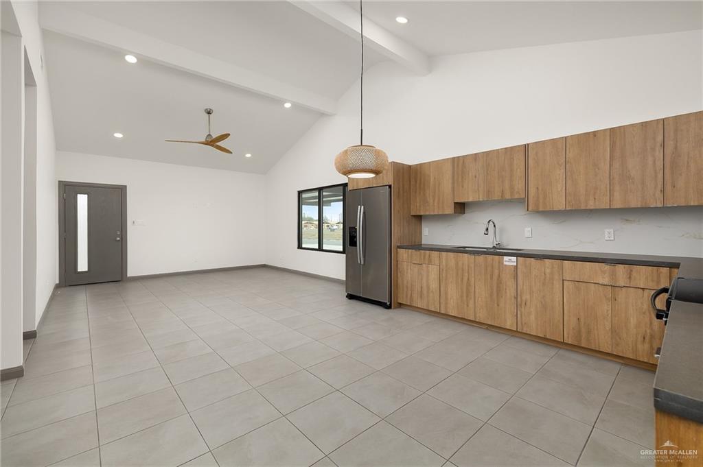2609 Woodpecker Road, Unit 1 Weslaco, TX 78596 - Photo 8 of 18 a kitchen with granite countertop a sink cabinets and window