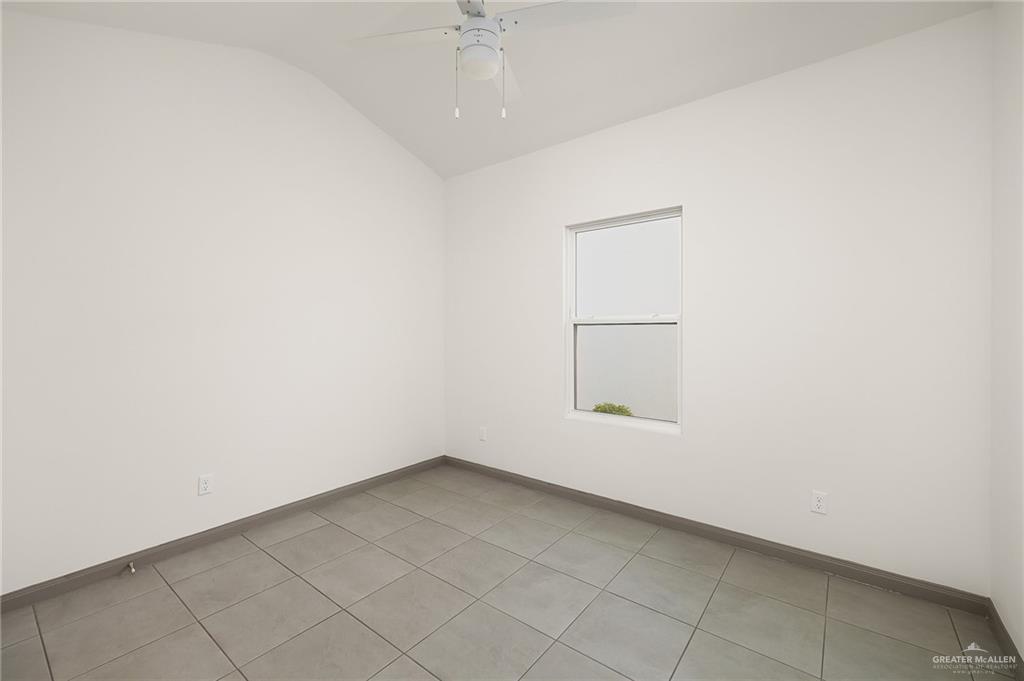 2609 Woodpecker Road, Unit 1 Weslaco, TX 78596 - Photo 9 of 18 an empty room with a empty space and a window