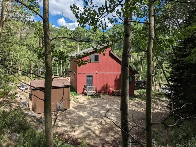 a front view of a house with trees