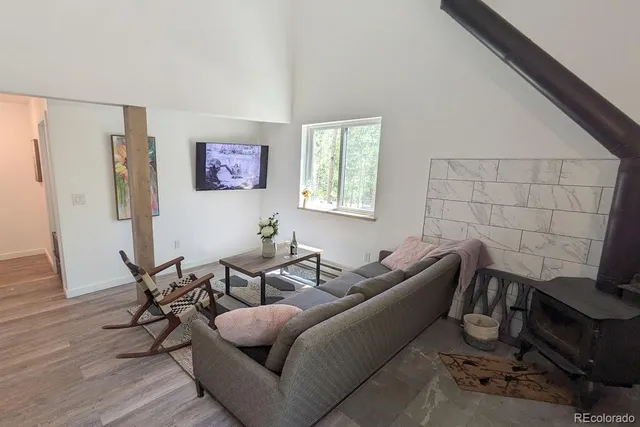 a living room with furniture a rug and a window