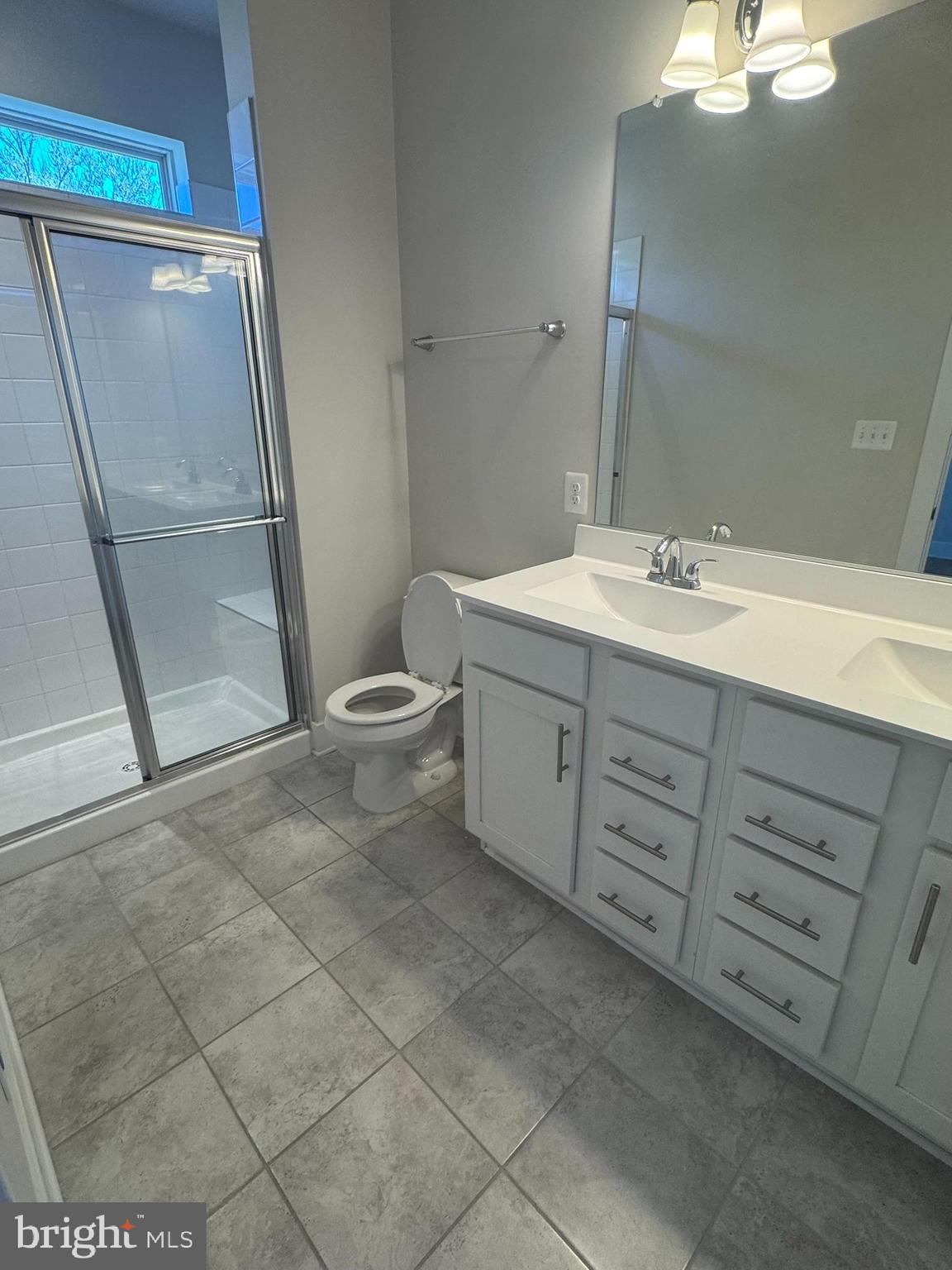 2921 Osprey Way Frederick, MD 21701 - Photo 15 of 27 a bathroom with a double vanity sink toilet and shower