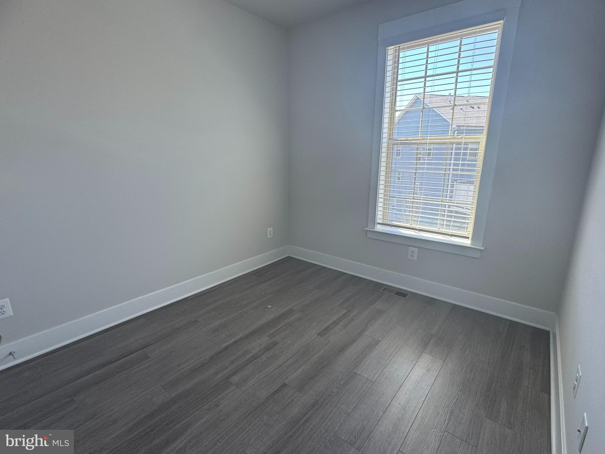 2921 Osprey Way Frederick, MD 21701 - Photo 19 of 27 an empty room with wooden floor and windows