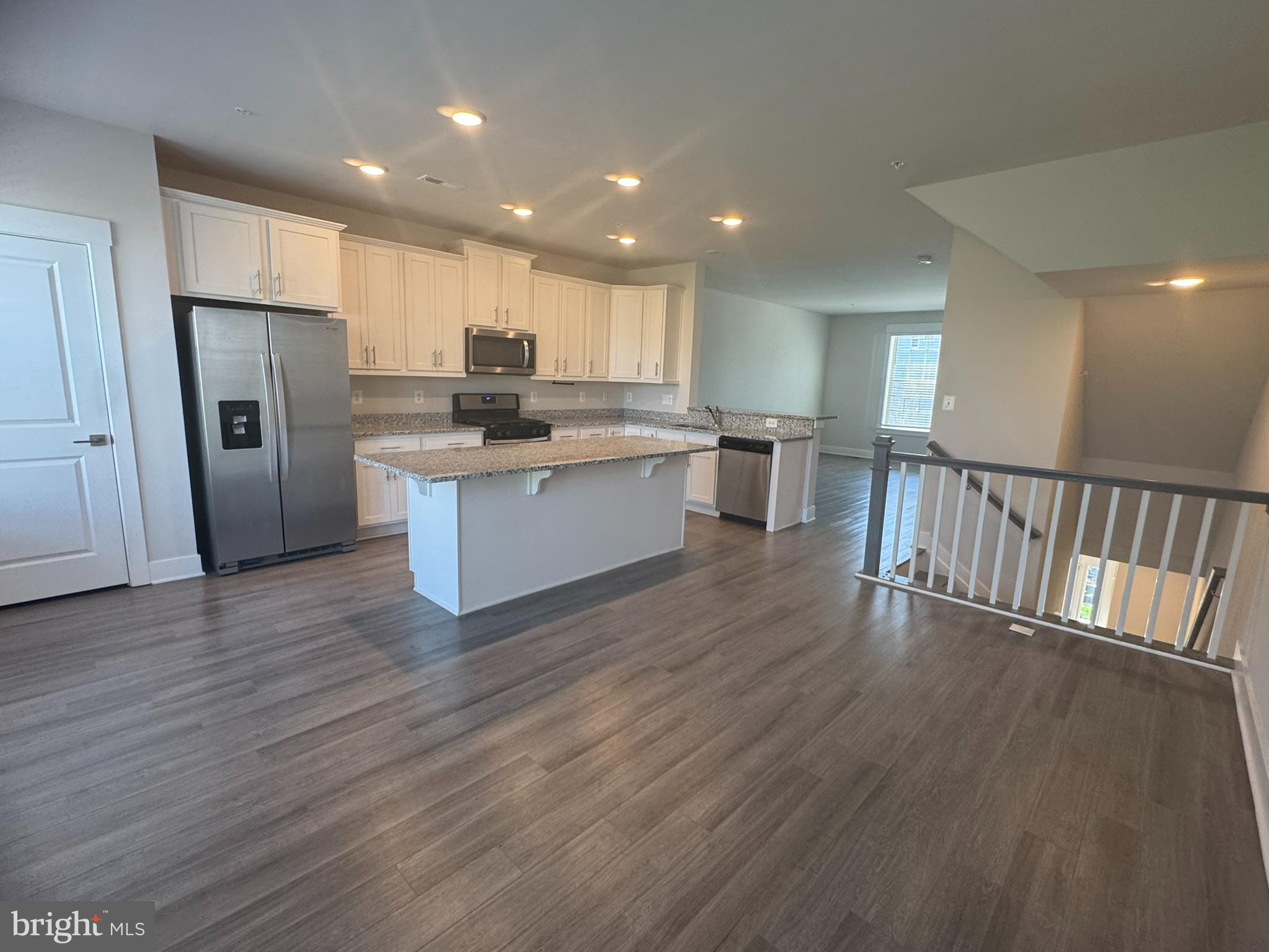2921 Osprey Way Frederick, MD 21701 - Photo 5 of 27 a kitchen with stainless steel appliances a refrigerator sink and wooden floor