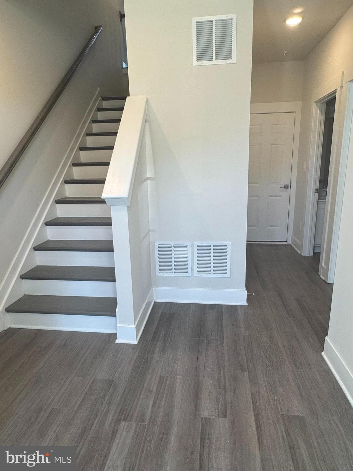 2921 Osprey Way Frederick, MD 21701 - Photo 8 of 27 a view of an empty room with wooden floor and stairs