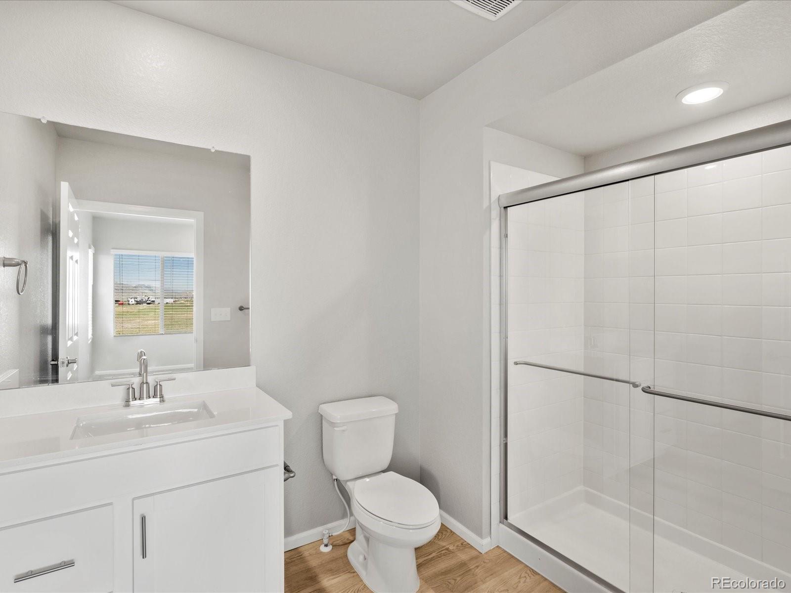 14451 Pansy Loop Morrison, CO 80465 - Photo 17 of 34 a bathroom with a toilet a sink and a shower