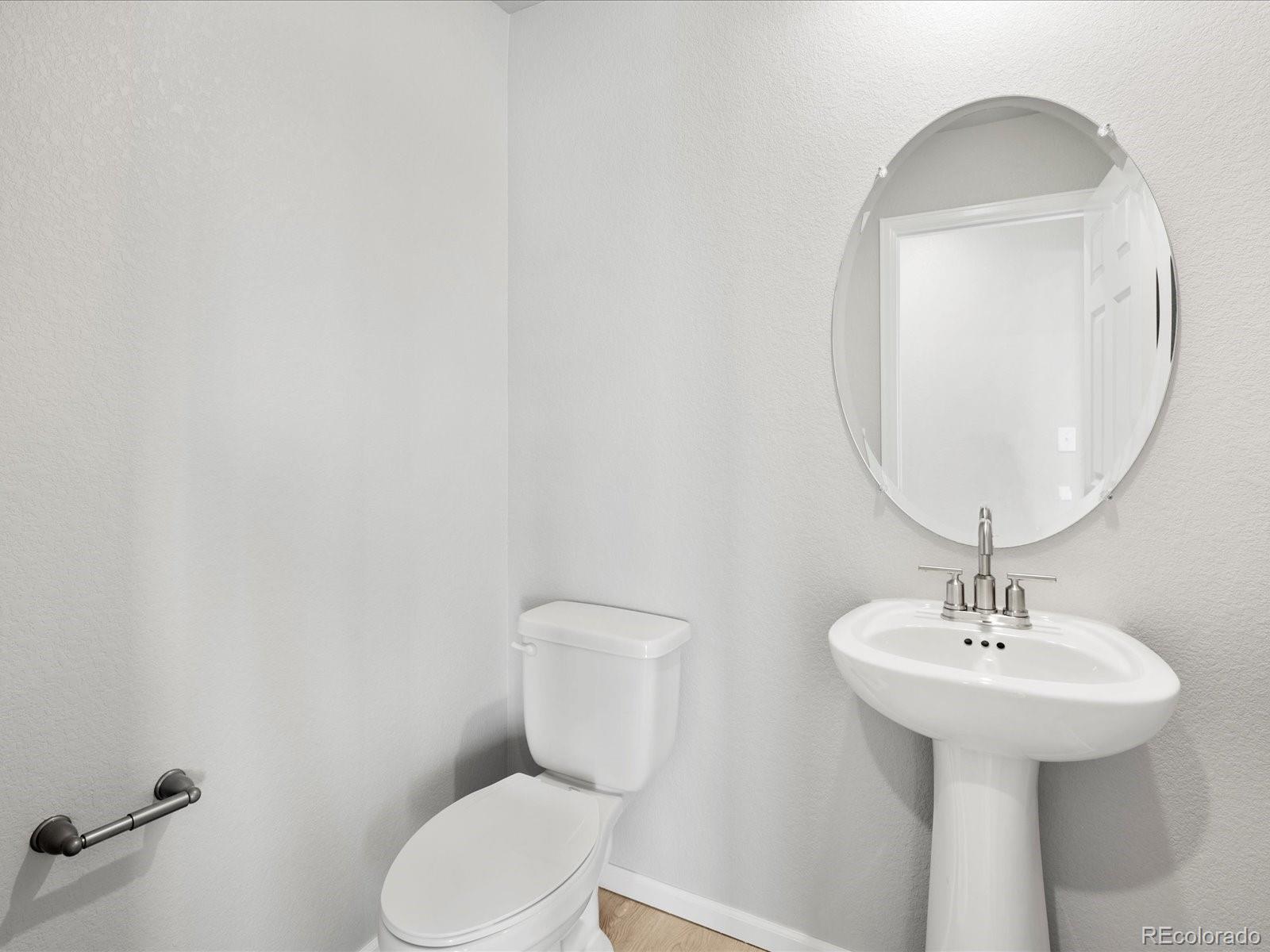 14451 Pansy Loop Morrison, CO 80465 - Photo 18 of 34 a bathroom with a toilet sink and mirror