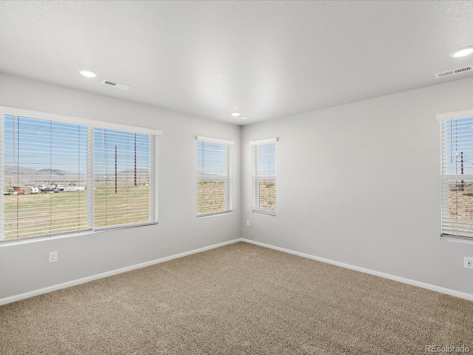 14451 Pansy Loop Morrison, CO 80465 - Photo 19 of 34 an empty room with windows