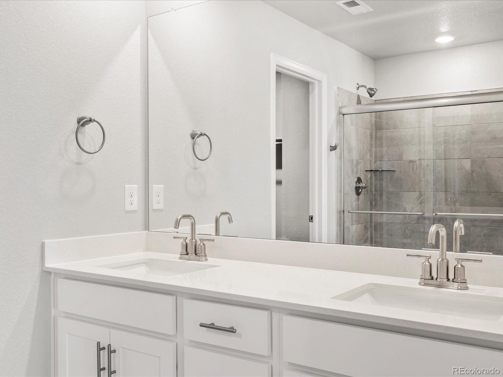 14451 Pansy Loop Morrison, CO 80465 - Photo 24 of 34 a bathroom with a sink and a mirror
