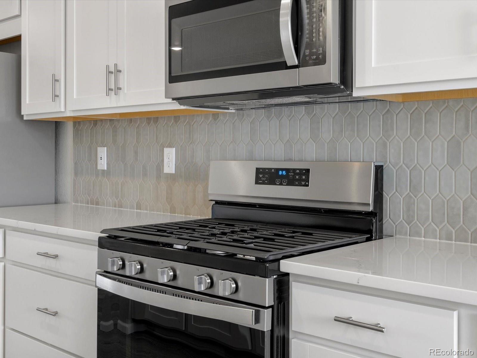 14451 Pansy Loop Morrison, CO 80465 - Photo 7 of 34 a stove top oven sitting inside of a kitchen