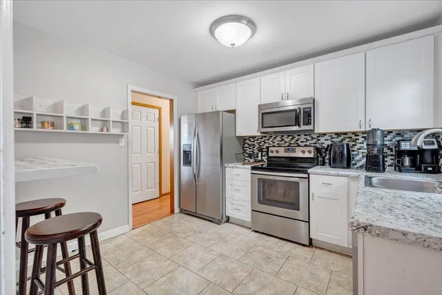 a kitchen with a stove microwave and refrigerator