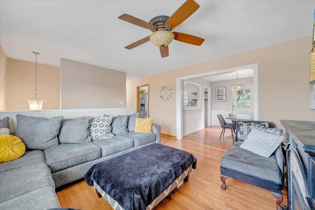 a living room with furniture rug and wooden floor